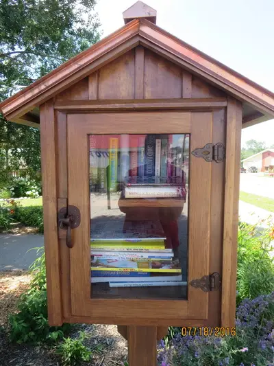 Little Free Library stocked with books in the town park