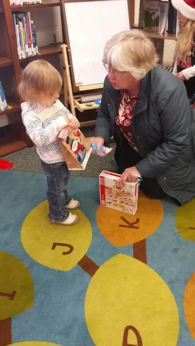 toddler & adult in library