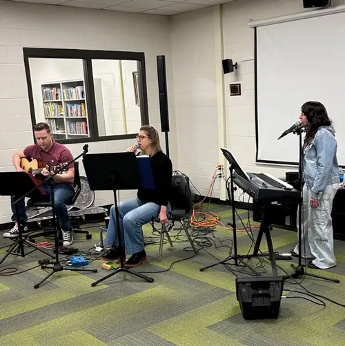 3-pc music group performing in the library