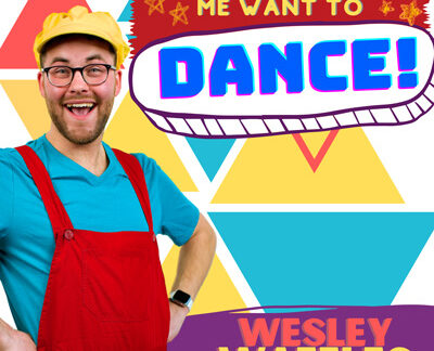 smiling Wesley Waffles wearing a blue tshirt, red overalls, yellow hat and glasses