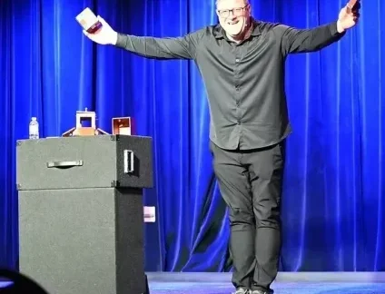 Jim Lenz on stage doing magic