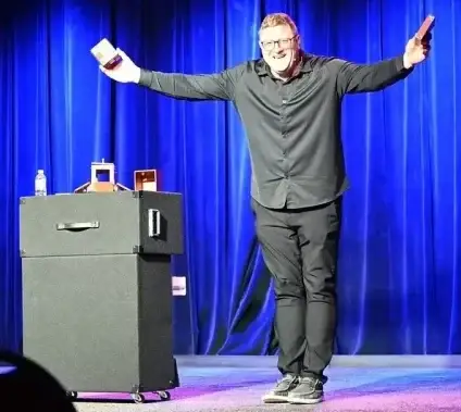 Jim Lenz on stage doing magic